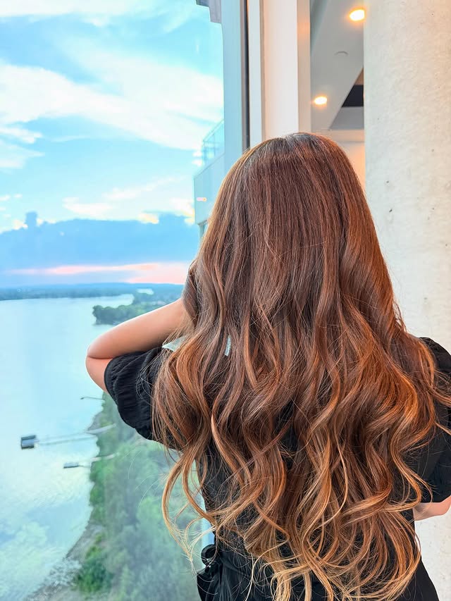 Caramel balayage waves with sunset backdrop