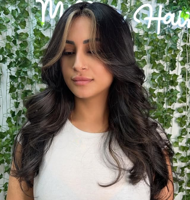 Voluminous dark curtain bangs blowout